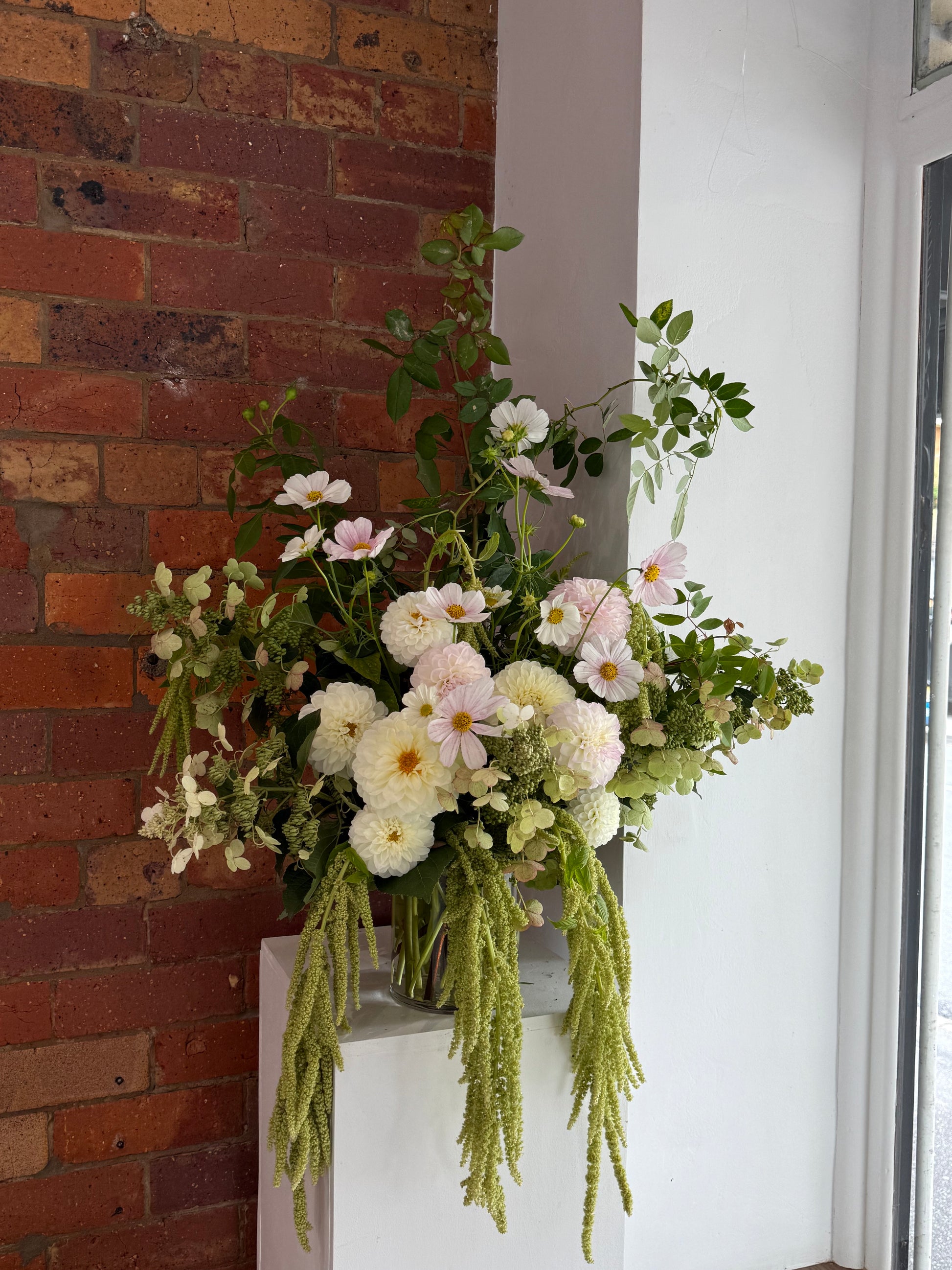 Floral arrangement on a brick wall background